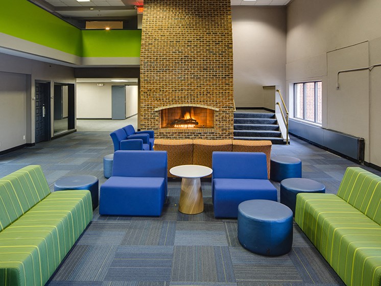 lobby with multicolored lounge chairs and a fireplace